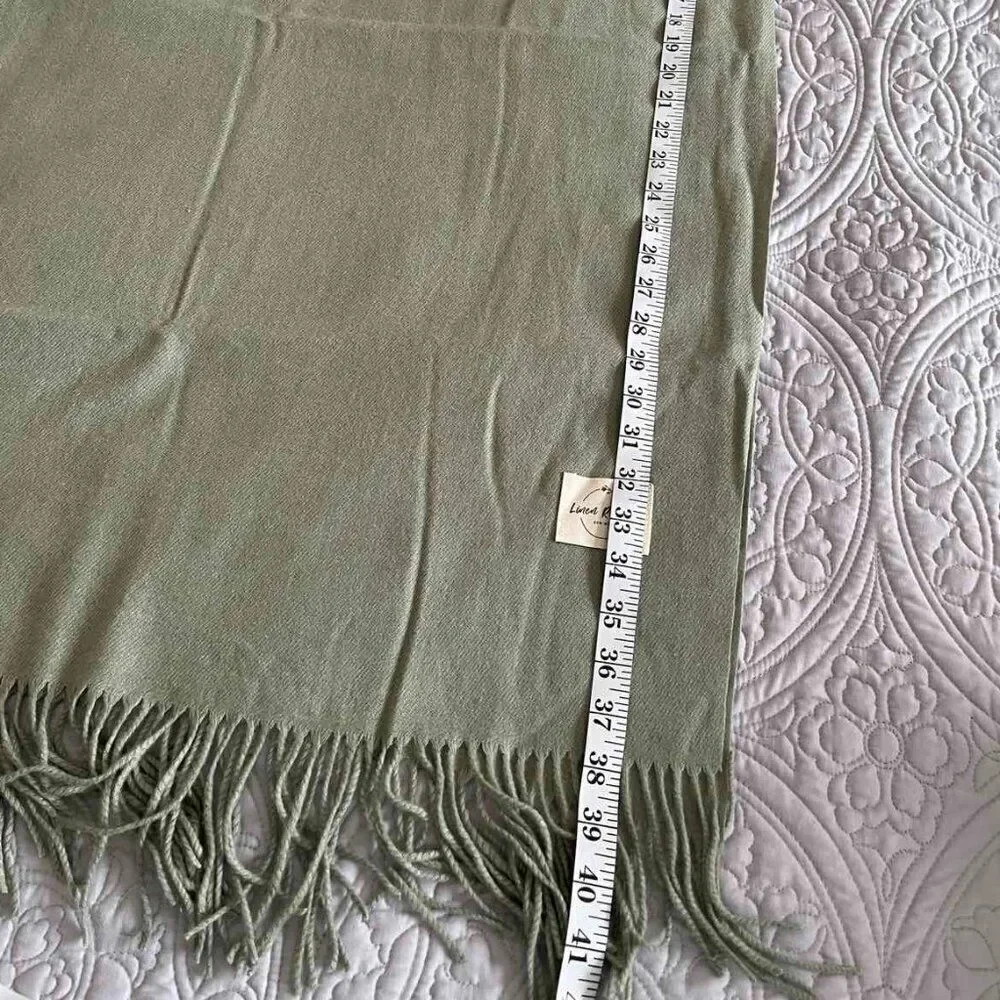 The soft warm pistachio-colored scarve made of a mixture of acrylic and cashmere